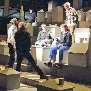 Ganzes Dorf zum Leben erweckt - Feilen an den Details: Regisseur Dodó Deér (2. von links) im Gespräch mit Autor Paul Steinmann (im Pullover mit Karo-Muster), dem Lichttechniker und einem Teil des Ensembles. Bild: Chregi Hansen